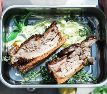 Cooked pork belly with fennel and salt in tray