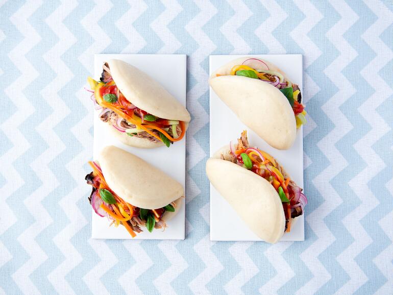 smoked pulled pork in bao hirata buns on a cloth background