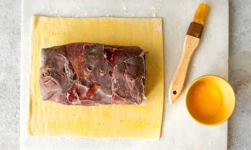 beef fillet covered with duxelle and ham on the pastry sheet 