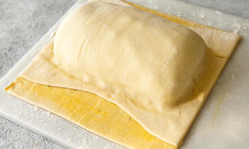 beef fillet covered with duxelle and ham on the pastry sheet covered with top layer pastry