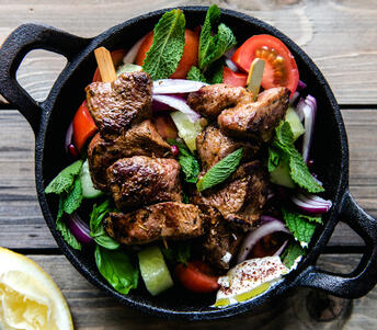 lamb leg skewers, sumac labneh & salad cooked