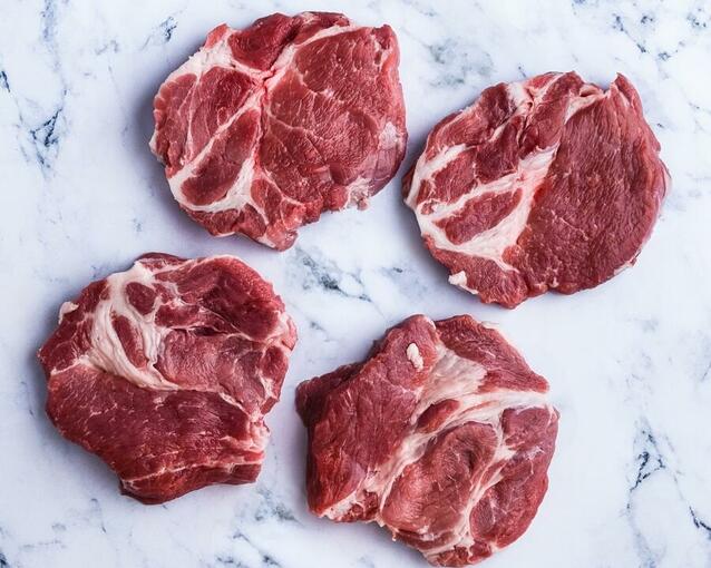 pork rib eye steaks on marble 