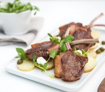cooked lamb tomahawk chops with new potatoes 
