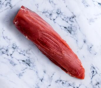 raw pork tenderloin on marble